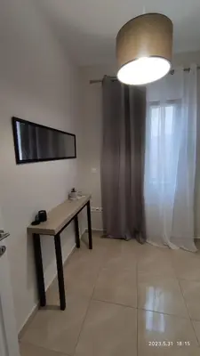a room with a table and a television and a window at Urbi Garden in Artemida
