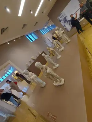 a group of dog statues sitting on the floor in a room at Urbi Garden in Artemida