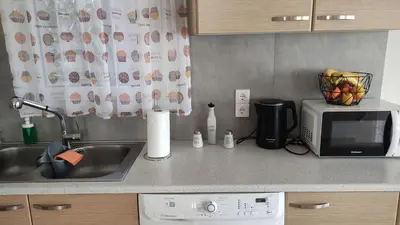 a kitchen counter with a sink and a microwave at Urbi Garden in Artemida