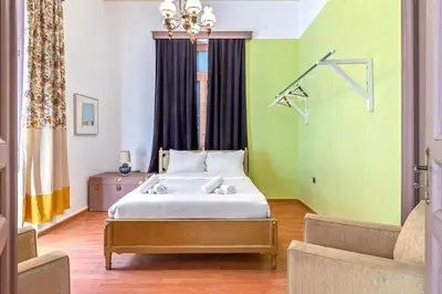 a bedroom with a bed in a room with green walls at 4 Bedroom Vintage House in heart of Pagrati Athens in Athens