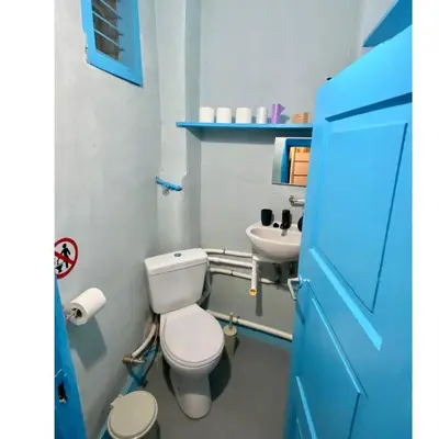 a bathroom with a white toilet and a sink at 4 Bedroom Vintage House in heart of Pagrati Athens in Athens