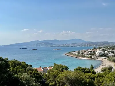 a view of a beach with a town and the ocean at Stunning View Seaside 1-Bed Apartment in Saronida in Saronida