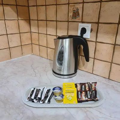 a coffee pot on a counter next to a tray of snacks at Garden View Apartment in Athens