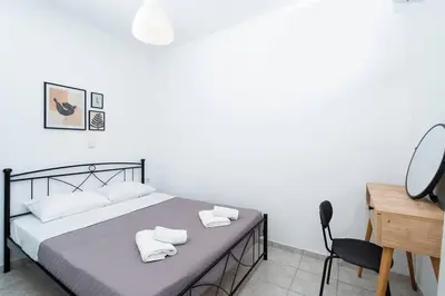 a bedroom with a bed with two towels on it at Omnia Maisonette by A&D Properties in Porto Rafti