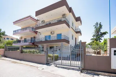 a building with a gate in front of it at Omnia Maisonette by A&D Properties in Porto Rafti
