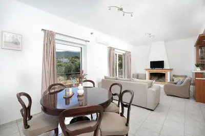 a living room with a table and a couch at Omnia Maisonette by A&D Properties in Porto Rafti