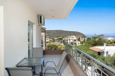 a balcony with a table and chairs on a building at Omnia Maisonette by A&D Properties in Porto Rafti