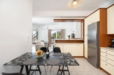 a kitchen with a table with a bowl of fruit on it at Omnia Maisonette by A&D Properties in Porto Rafti