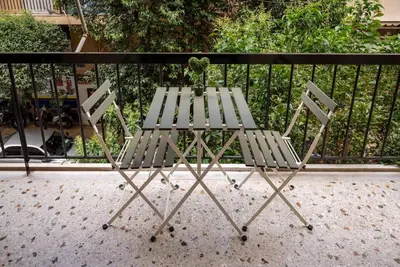 a table and two chairs sitting on a balcony at The Athenian Hideaway 2- Bedroom apartment in Thiseio in Athens