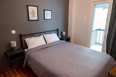 a bedroom with a large bed with two night stands at The Athenian Hideaway 2- Bedroom apartment in Thiseio in Athens