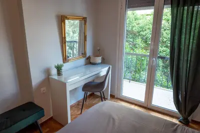 a bedroom with a bed and a desk and a window at The Athenian Hideaway 2- Bedroom apartment in Thiseio in Athens