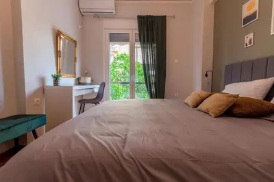 a bedroom with a large bed with a window at The Athenian Hideaway 2- Bedroom apartment in Thiseio in Athens