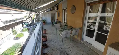 a balcony with a table and chairs on a building at Retro Stay Athens in Athens