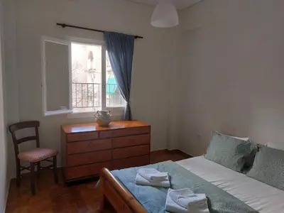 a bedroom with a bed and a dresser and a window at Retro Stay Athens in Athens