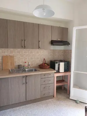 a kitchen with wooden cabinets and a sink and a microwave at Retro Stay Athens in Athens
