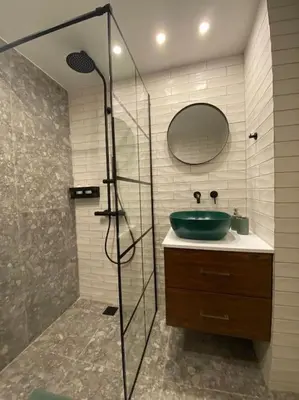 a bathroom with a glass shower and a sink at Piraeus cozy appartment rental in Piraeus