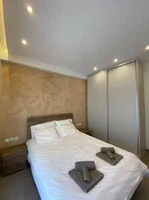 a bedroom with a bed with two towels on it at Piraeus cozy appartment rental in Piraeus