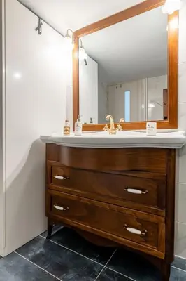 a bathroom with a sink and a mirror at Luxury flat at archaeological museum in Athens