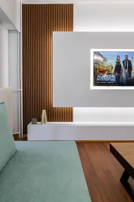 a living room with a tv on a wall at Luxury flat at archaeological museum in Athens