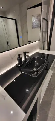 a bathroom with a black sink and two windows at LView Acropolis in Athens
