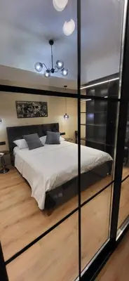 a bedroom with a large bed with glass walls at LView Acropolis in Athens