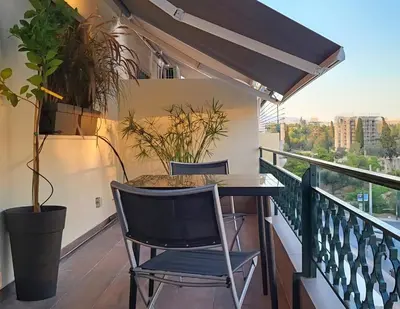 a balcony with a table and a potted plant at LView Zeus Temple in Athens