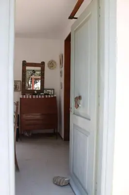 a hallway with a door and a dresser and a mirror at Aegean traditional home in Athens Riviera in Sounio