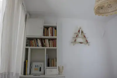 a book shelf filled with books and a christmas ornament at Aegean traditional home in Athens Riviera in Sounio