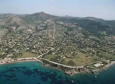 an aerial view of a town next to the ocean at Aegean traditional home in Athens Riviera in Sounio