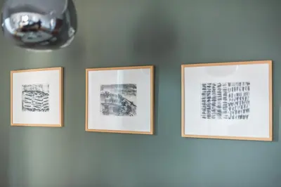 three framed pictures hanging on a wall at Syntagma SQ Residence in Athens
