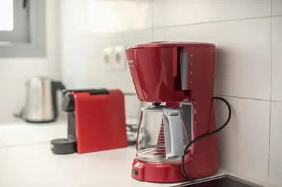 a red blender sitting on a counter in a kitchen at Syntagma SQ Residence in Athens