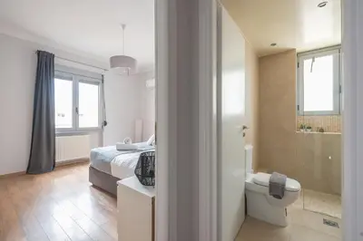 a bedroom with a bed and a bathroom with a toilet at Syntagma SQ Residence in Athens