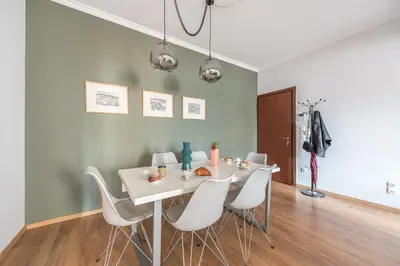 a dining room with a white table and white chairs at Syntagma SQ Residence in Athens