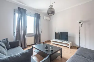 a living room with two couches and a tv at Syntagma SQ Residence in Athens