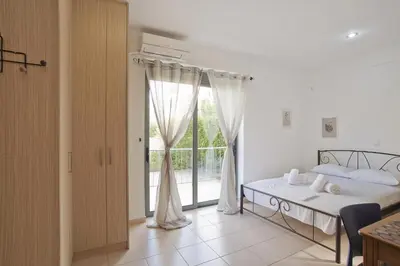 a bedroom with a bed and a large window at Glyfada Cozy Studio, WiFi, AC in Athens