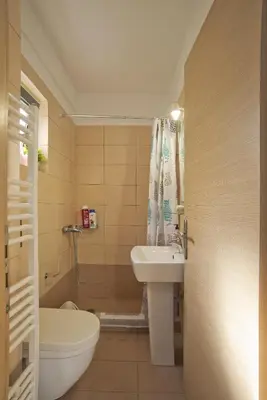 a bathroom with a sink and a toilet and a tub at Glyfada Cozy Studio, WiFi, AC in Athens