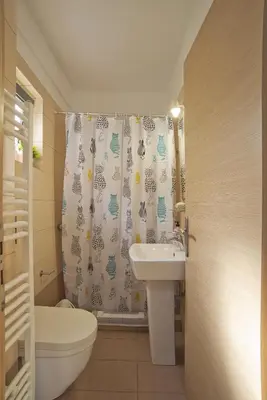 a bathroom with a sink and a toilet and a shower curtain at Glyfada Cozy Studio, WiFi, AC in Athens