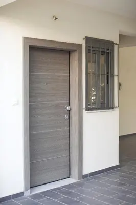 a garage door in a house with a window at Glyfada Cozy Studio, WiFi, AC in Athens