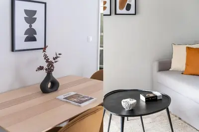 a living room with a table and a couch at Smart Chic 1BR Apartment in Agia Paraskevi by UPSTREET in Athens