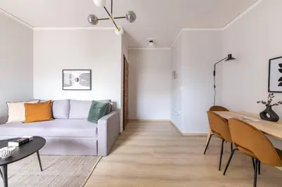 a living room with a couch and a table at Smart Chic 1BR Apartment in Agia Paraskevi by UPSTREET in Athens