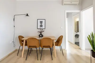 a dining room with a table and chairs at Smart Chic 1BR Apartment in Agia Paraskevi by UPSTREET in Athens
