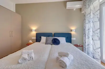 a bedroom with a bed with towels on it at Deluxe Urban 2BR Apt by Nat. Archaelogical Museum in Athens