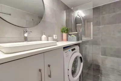 a bathroom with a washing machine and a sink at Deluxe Urban 2BR Apt by Nat. Archaelogical Museum in Athens
