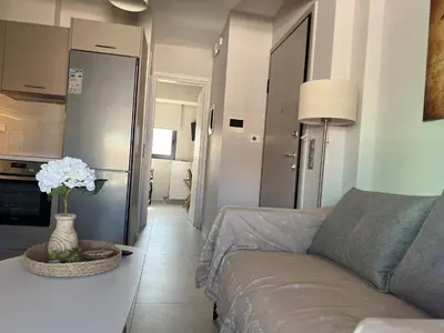 a living room with a couch and a table at Elia's Apartment in Athens