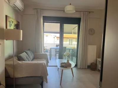 a living room with a couch and a table at Elia's Apartment in Athens