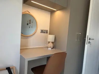 a room with a desk with a lamp and a mirror at Elia's Apartment in Athens