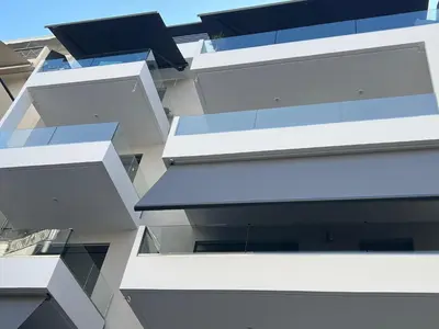 a building with white balconies on the side of it at Elia's Apartment in Athens