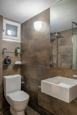 a bathroom with a toilet and a sink and a shower at Central Athenian 1BR Apartment in Athens