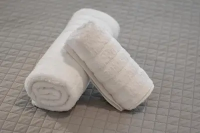 a roll of white toilet paper sitting on a bed at Central Athenian 1BR Apartment in Athens