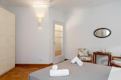 a white room with a bed and a mirror at Central Athenian 1BR Apartment in Athens